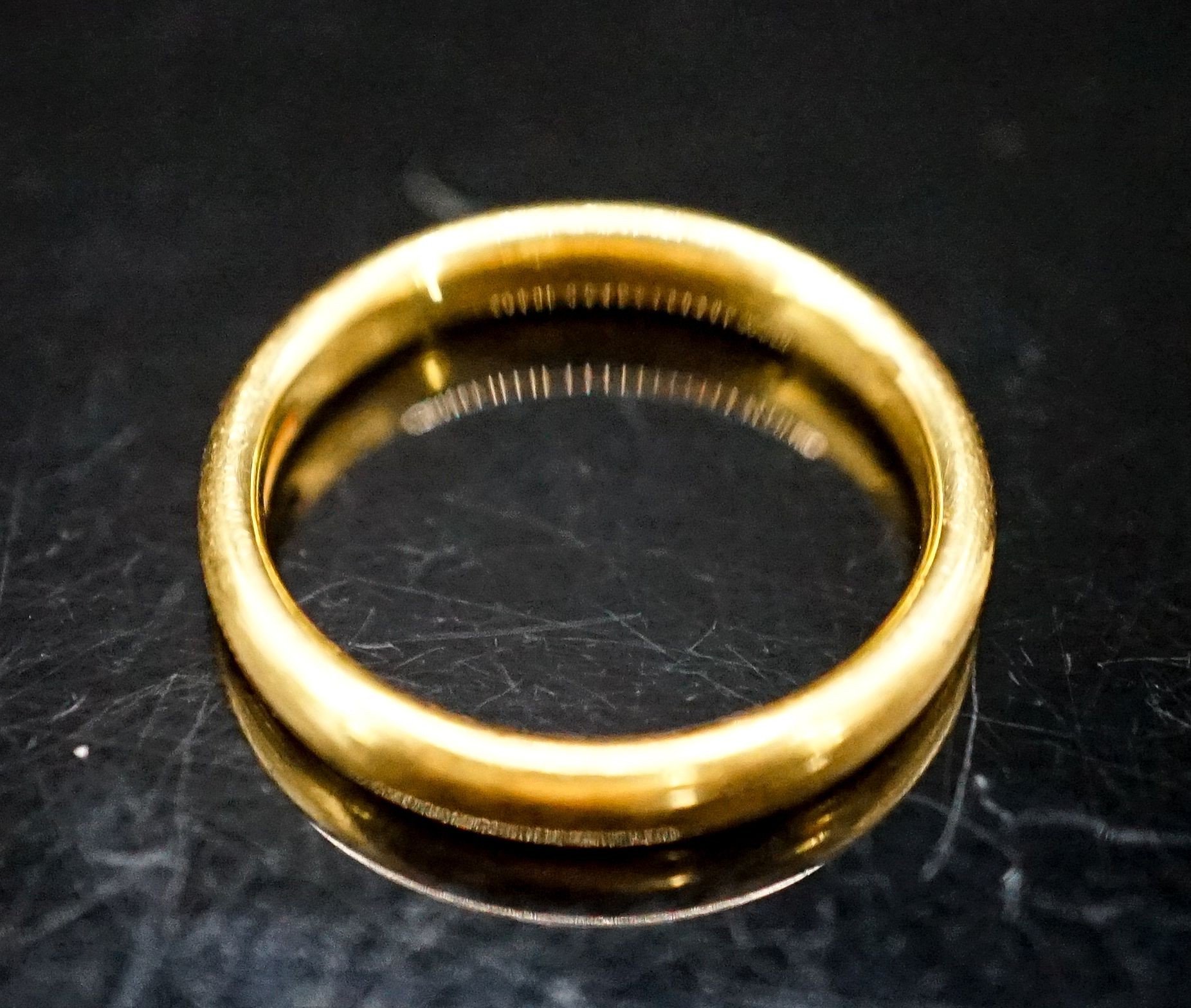 A 22ct gold wedding band, size L/M, 4.6 grams.